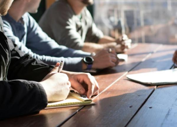 people writing on the table