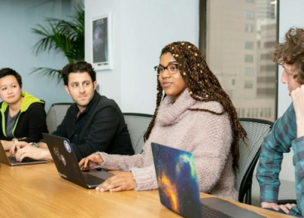 people with computers talking