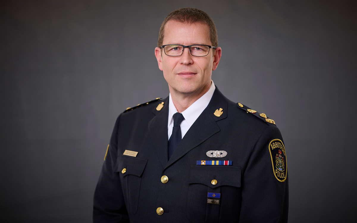 Head and shoulders image of man wearing glasses and uniform of Chief Constable of Abbotsford Police.