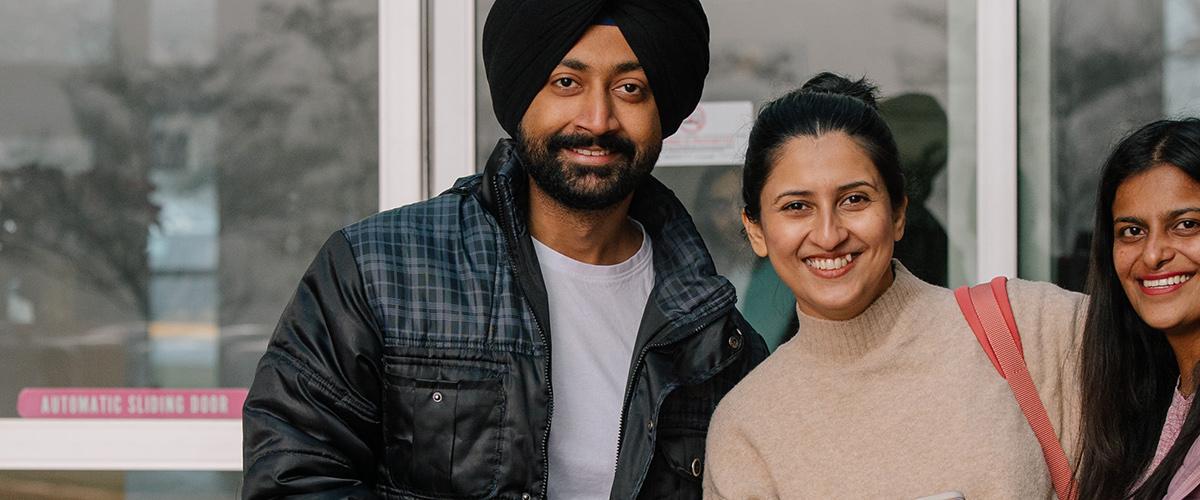 Three students looking at the camera