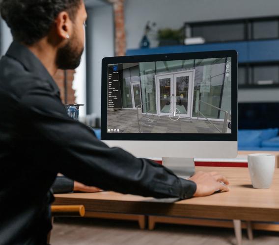 Man at computer screen showing sheriff training web app.