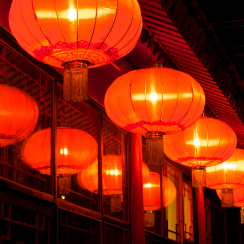 An image of four Lunar New Year lanterns hanging on a house.