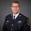 Head and shoulders photo of man wearing glasses and uniform of the chief constable of Abbotsford Police Department.
