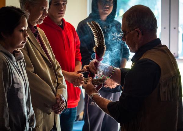 A group of people participating in an indigenous ceremony